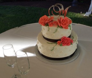 A two layer cake with flowers on top of it.